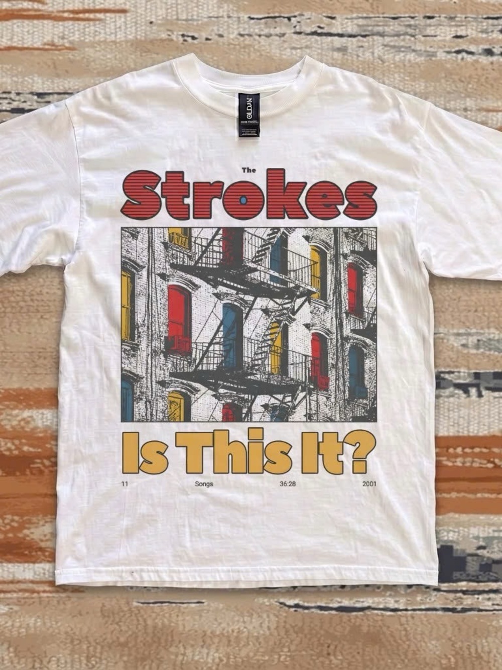 White T-shirt featuring The Strokes' "Is This It" album cover
